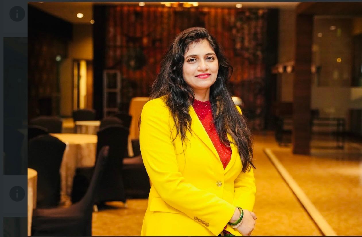 Ritu Singh standing confidently with a warm smile